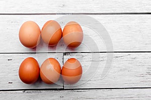 white egg on white wooden table. From above. Copy space