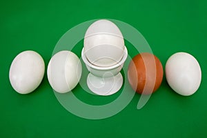 White eggs, brown egg, green background, green, background