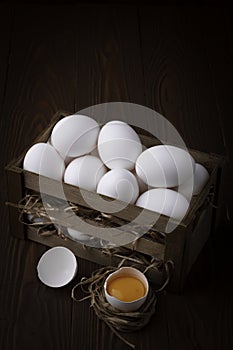 White eggs on brown wooden background