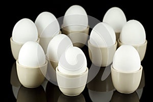 White eggs in egg-cups on black 3