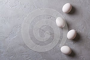 White eggs on a gray concrete table. Easter photo concept.