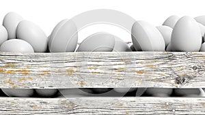 White eggs in old wooden container closeup