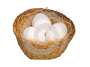 White eggs in a wicker basket isolated on white