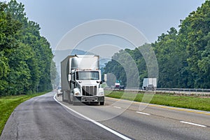 White Eighteen-Wheeler on Interstate With Room To Crop