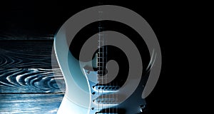 White electric guitar. Music concept. Creative style with light shadows