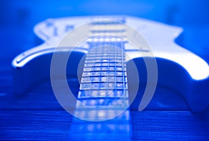 White electric guitar. Music concept. Creative style with light shadows