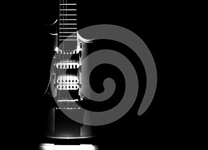 White electric guitar. Neck and fingerboard of musical instrument. Creative style with light shadows