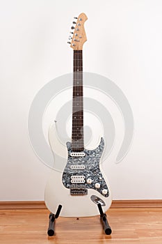 White electric guitar, studio shoot.  2 x Single Coil and 1 x Humbucking. Black Pearl pickguard, Rosewood Fingerboard photo