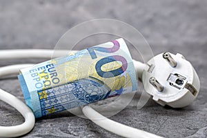 White electric plug and twenty euro close-up