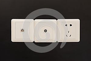 white electric plugs or outlet on wall, with tv and tel