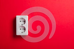 White electric socket on the wall.