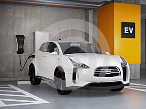 White electric SUV recharging in parking garage photo