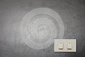 White electric switch on cement wall.