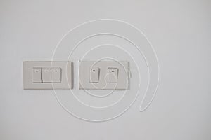 White electric turn on and off switch on white wall