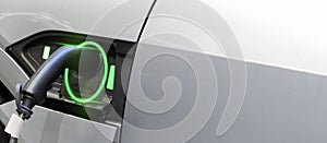 White electric vehicle charging station with power cable supply plugged station at home