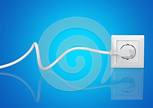 White electrical plug in the electric socket on a