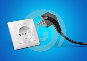 White electrical plug in the electric socket on a