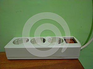 white electrical socket with three holes photo