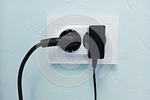 White electrical socket on  wall with electrical appliances turned on