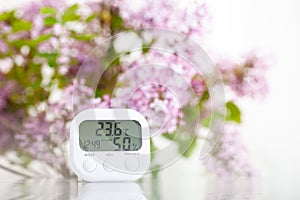 White electronic hygrometer on white table
