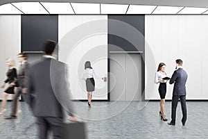 White elevator hall, people