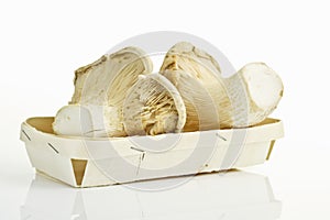 White elf mushrooms in wooden punnet