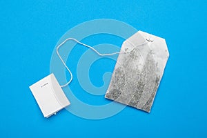 A white empty bag of organic tea on a blue background. Layout, mockup