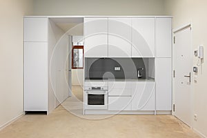 White empty classic kitchen in front view in new or refurbished apartment