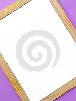 White empty clean school board on a purple background with a wooden brown frame. Back to school. Mockup.