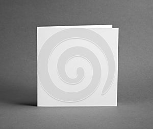 White empty closed card on grey to replace your design.