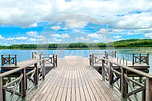 White empty deck chair at the lake dock.