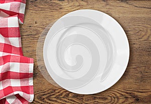 White empty dinner plate setting on wooden table
