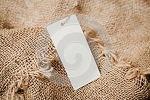 white empty label tag on vintage burlap background