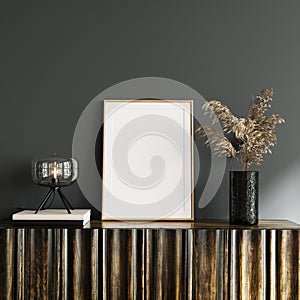 White empty mockup picture frame on wooden console with dry plant decoration and glass table lamp