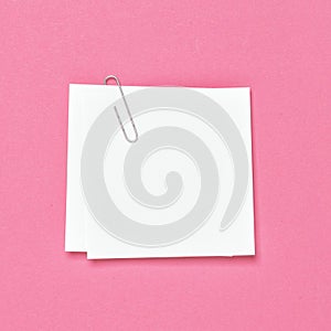 White empty note paper sheet paperclip pink