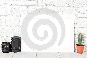 White empty photo frame against brick wall. Mockup with copy space