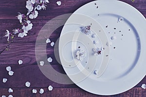 White empty plate on a brown wooden surface