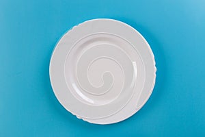 White empty plate top view on table