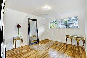 White empty room with antique tables and mirror