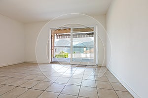 White empty room with tiles and windows