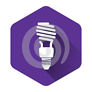 White Energy saving light bulb icon isolated with long shadow. Purple hexagon button
