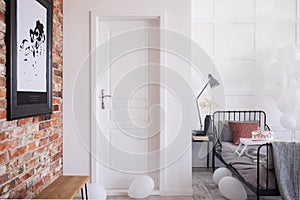 White entrance door to stylish bedroom interior, real photo with copy