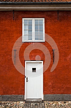 White Entry Door and Window in Red Brick Building, Close Up, Exterior