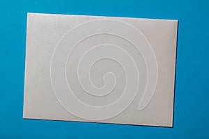 white envelope blank note pinned to a blue notice board