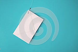 White envelope on the fish hook. Phishing email concept