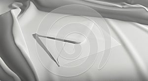 A white envelope rests on a smooth, flowing white fabric surface. The envelope is