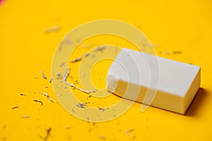 White eraser on a yellow background. Rubbish from erasure