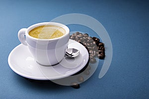White espresso cup and saucer with brown coffee