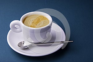 White espresso cup and saucer with brown coffee