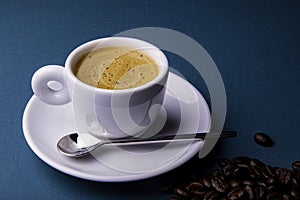 White espresso cup and saucer with brown coffee